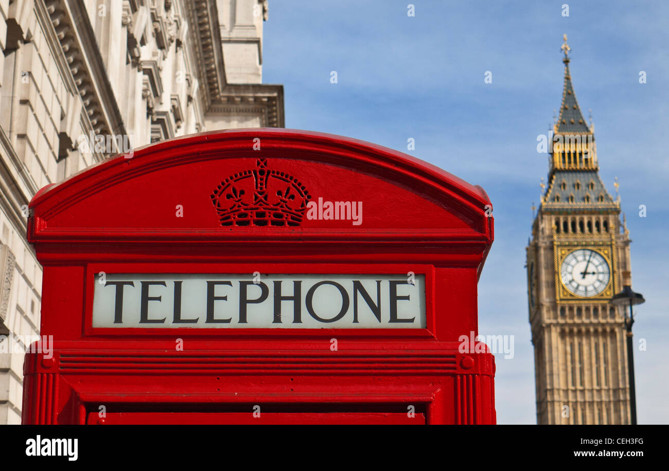 Red telephone box traditional London scene, with Big Ben clock tower behind Westminster London UK Stock Photo