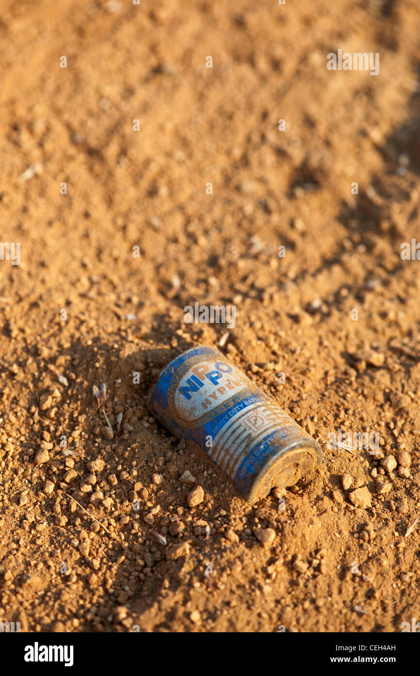 Discarded battery in the earth in the Indian countryside Stock Photo