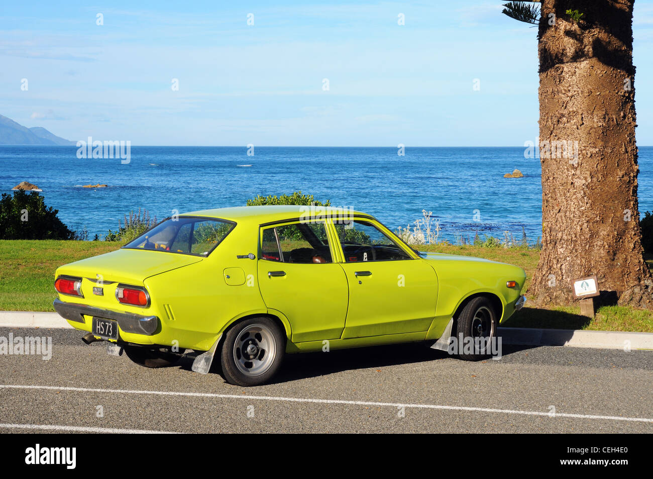 A Datsun 120Y parked on the seafront at Kaikoura in New Zealand Stock Photo
