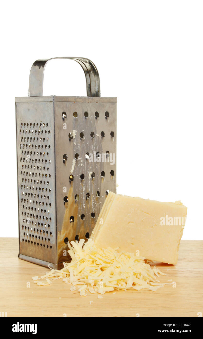 Cheese grater and cheddar cheese on a wooden board Stock Photo