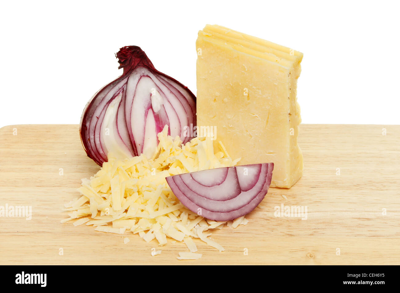 Cheddar cheese and red onion on a wooden food preparation board Stock Photo