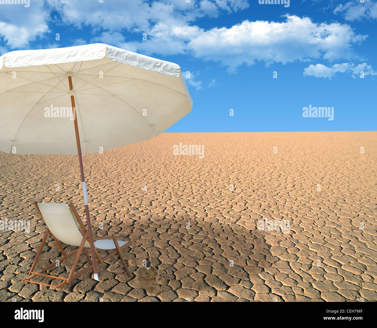 White umbrella and wooden chair in desert Stock Photo