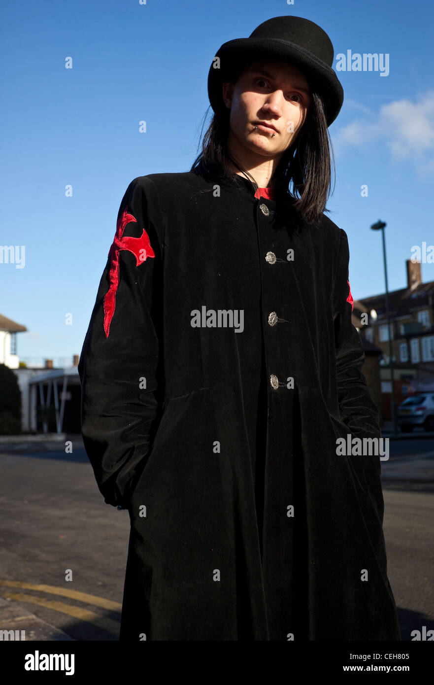 Portrait of a Goth young man wearing long black coat and a hat, London, England, UK Stock Photo