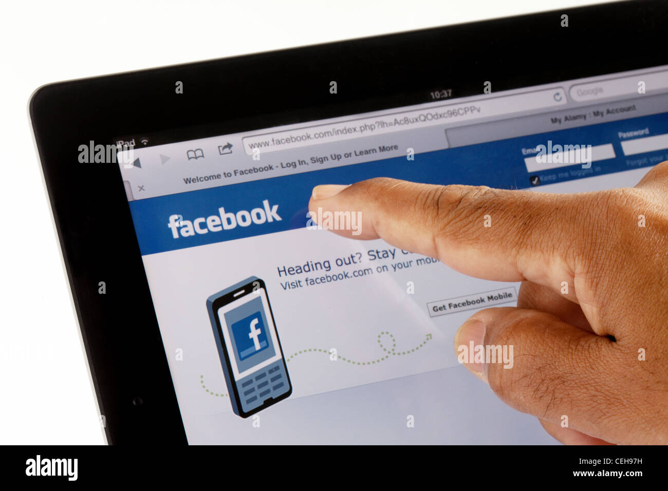 facebook  website on Apple iPad2 and finger pointing Stock Photo
