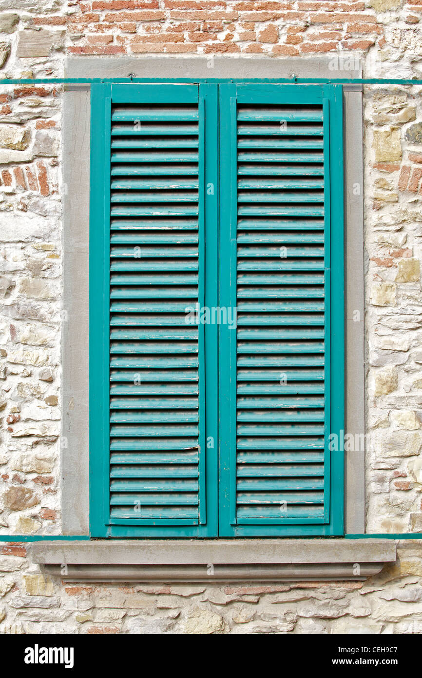 Green Wood Window Shutters Against a Stone Wall Stock Photo - Alamy