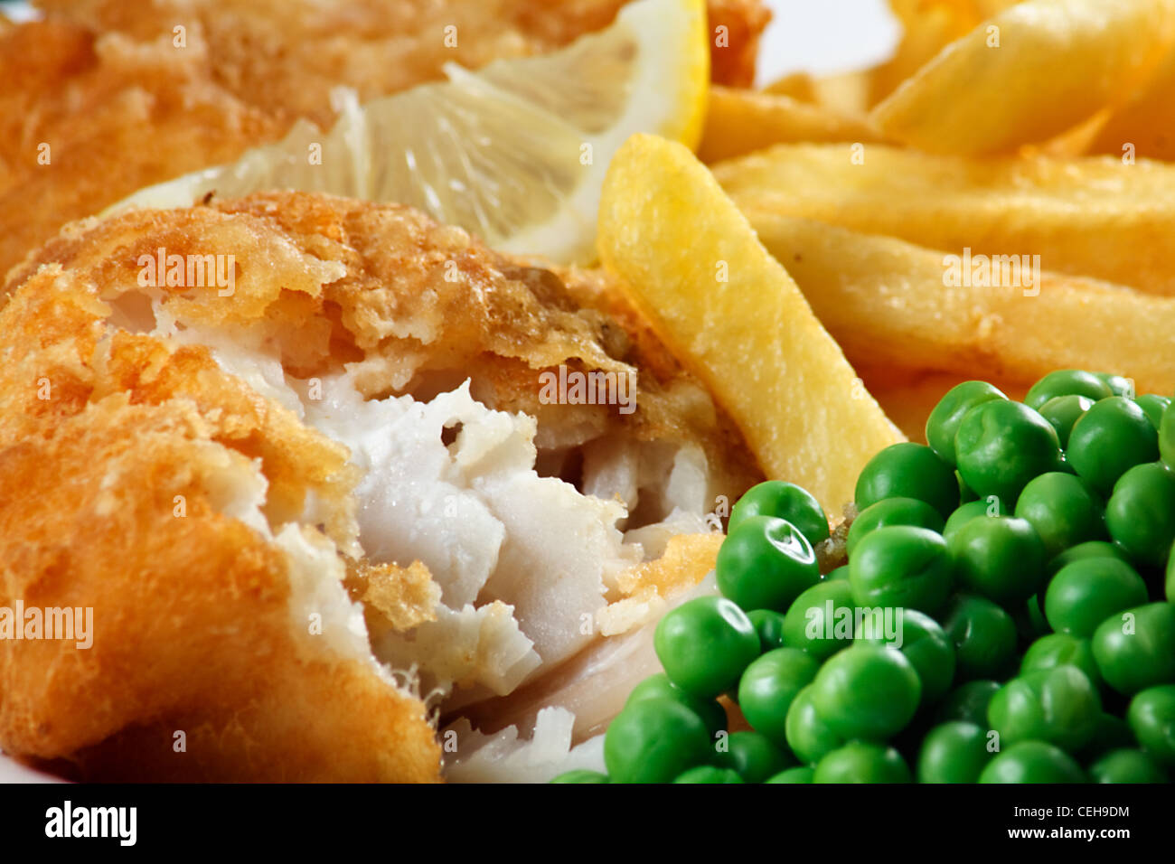 Close up of fish and chips with peas and a slice of lemon. A traditional British Seaside Dish Stock Photo