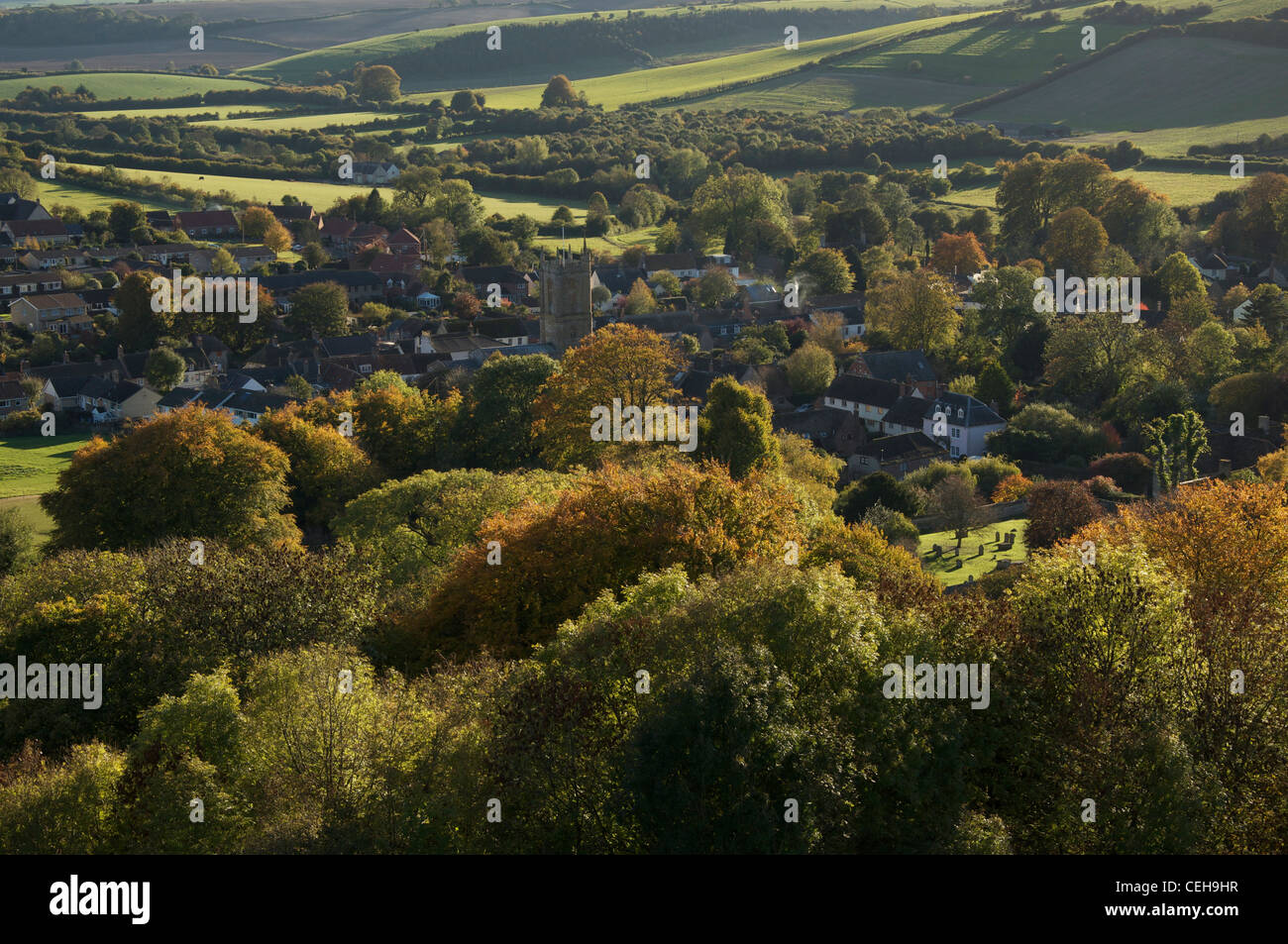 English countryside. The view over the Dorset village of Cerne Abbas, from Giant Hill. Autumnal colours glowing in the evening sunshine. England, UK. Stock Photo