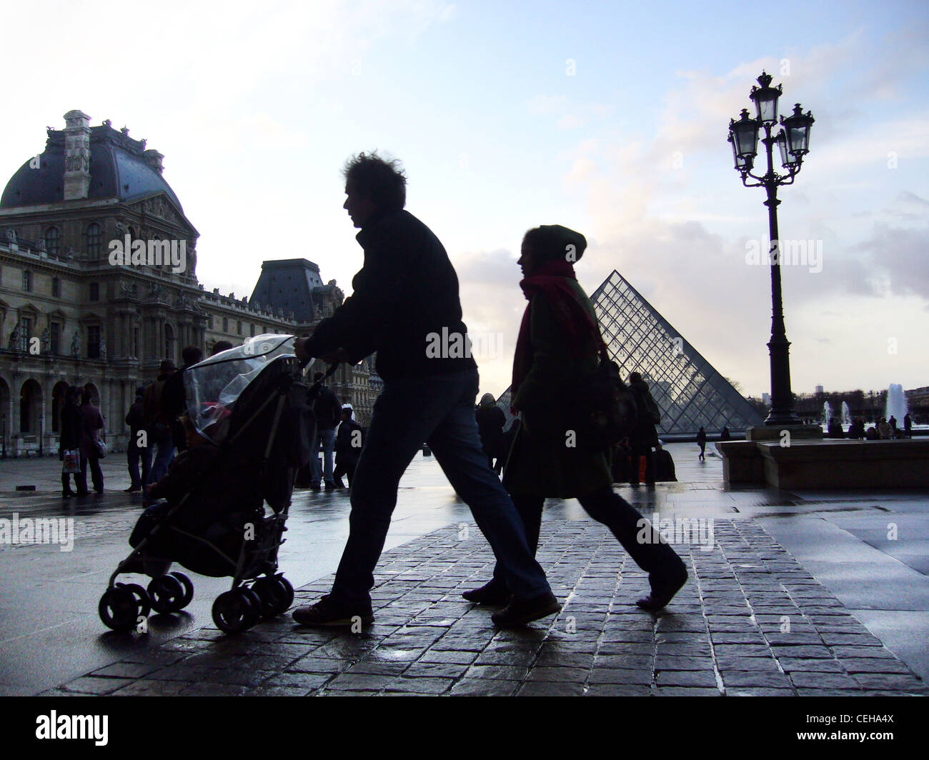 Silhouettes on a rainy day in Place du Carrousel du Louvre, Paris, France Stock Photo