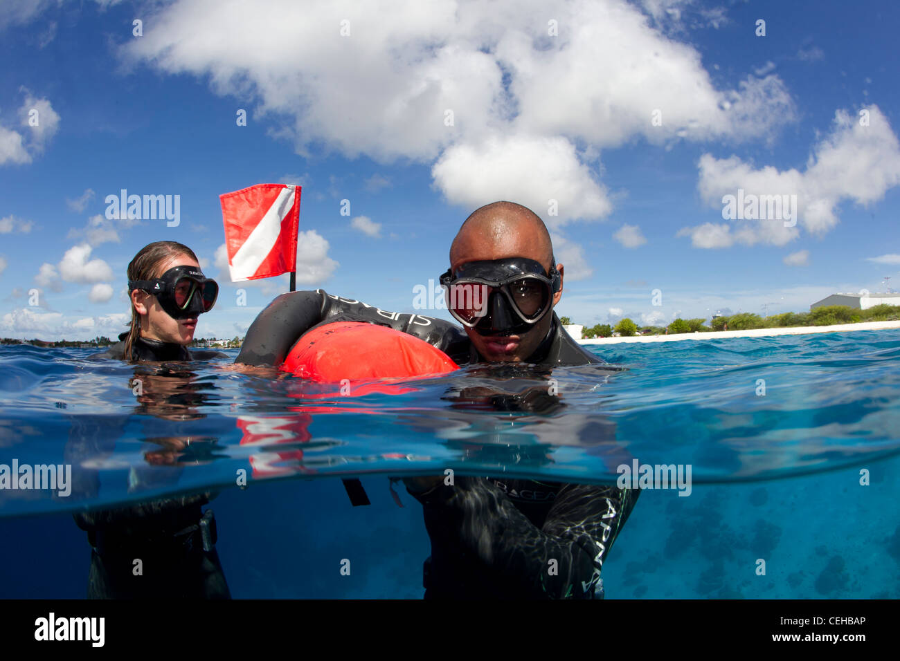 Freedivers catch breath at surface Stock Photo