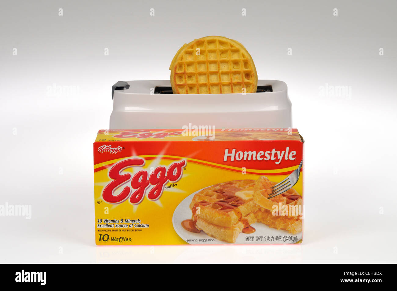 Box of Eggo frozen waffles on white background in front of toaster with eggo waffle in it cutout USA Stock Photo