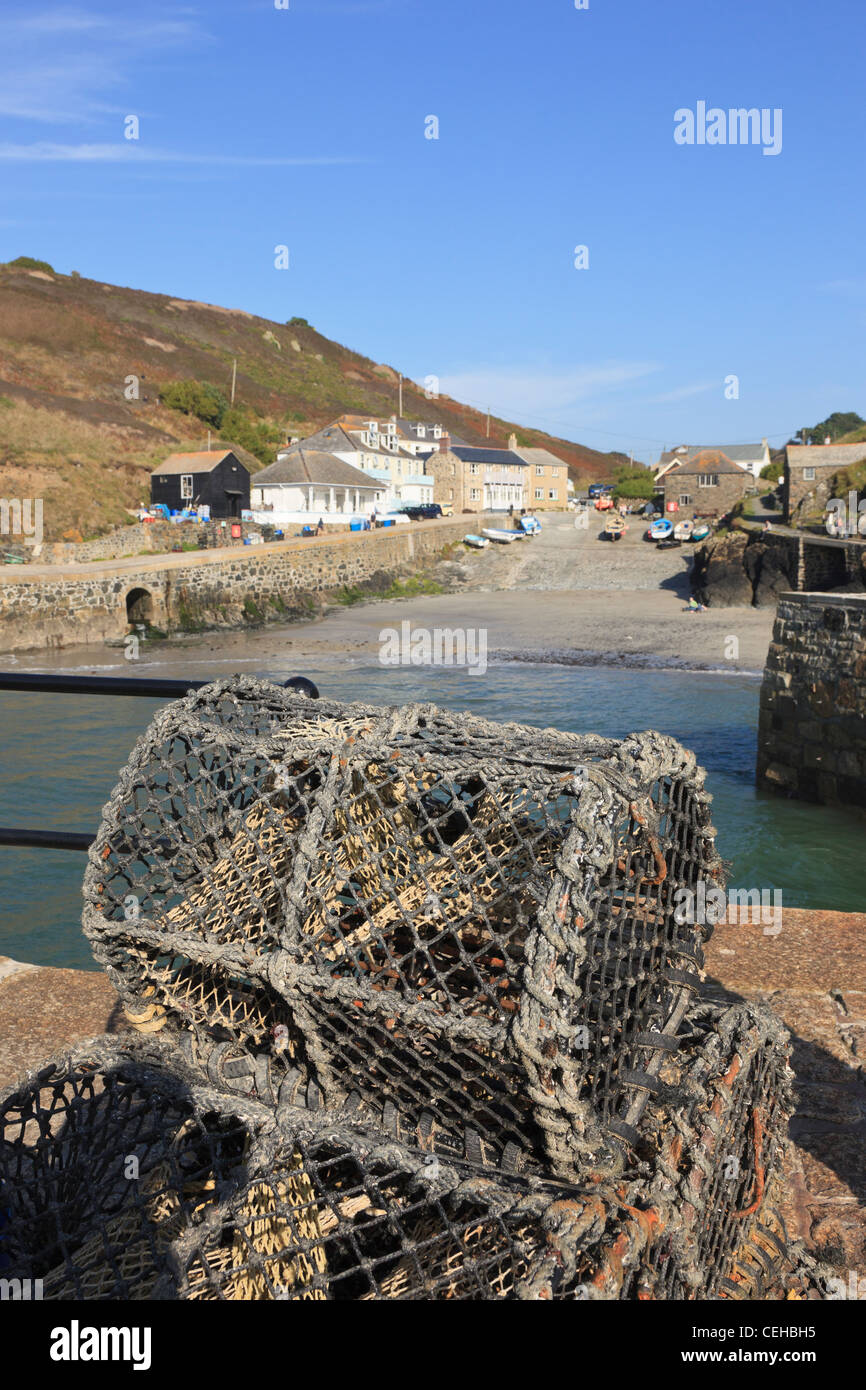 Lobster pots on the harbour wall in picturesque fishing village on the Cornish coast. Mullion Cove Cornwall England UK Britain Stock Photo