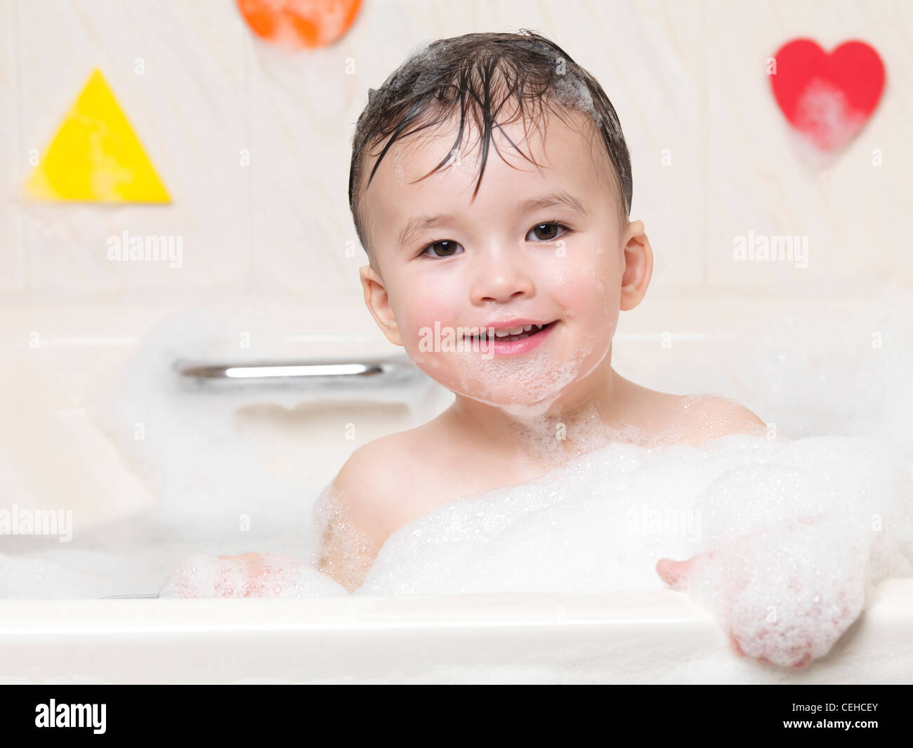 Cute Smiling Two Year Old Child Enjoying A Bubble Bath Stock