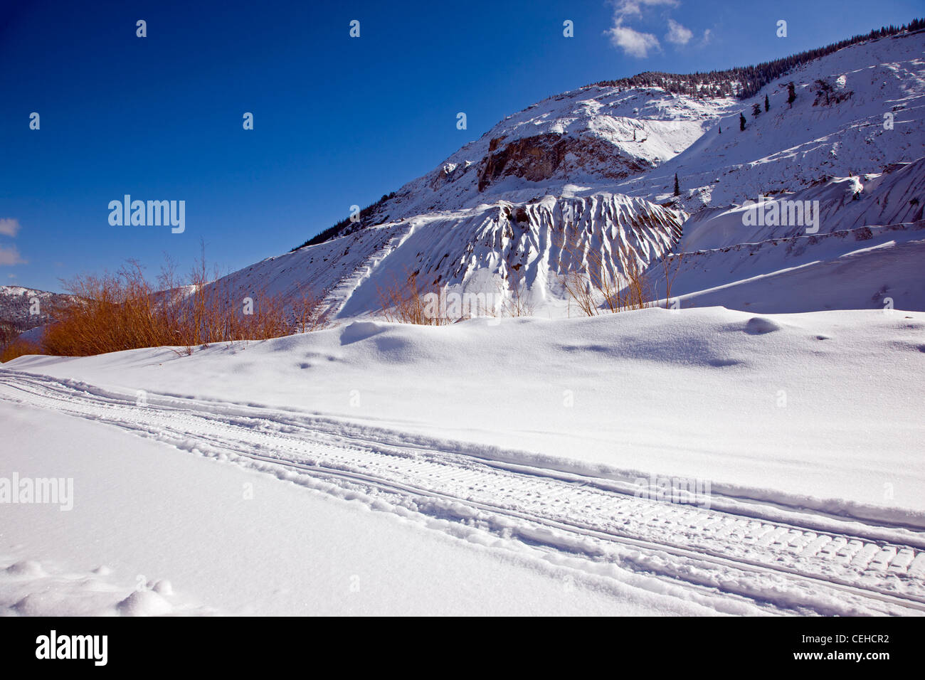 Fresh snowmobile tracks on a snow covered mountain road near Monarch