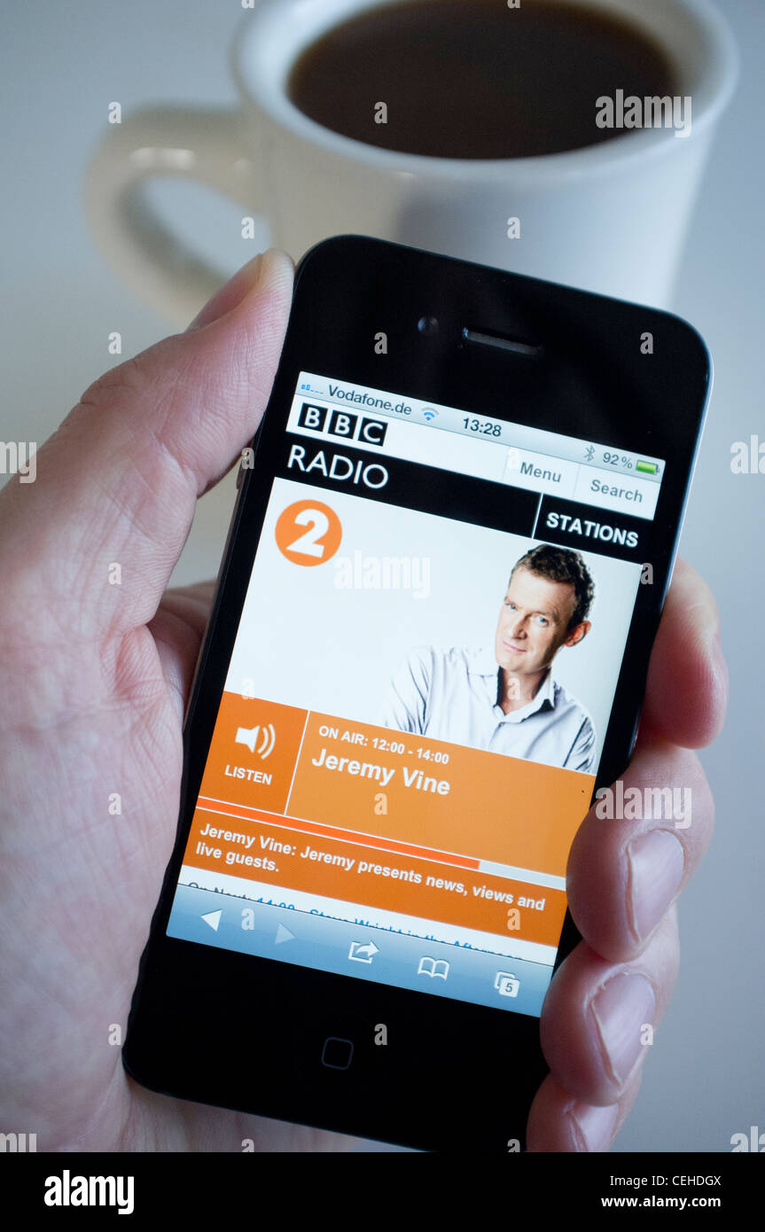 Listening to streaming BBC Radio 2 on an iPhone 4G smart phone Stock Photo