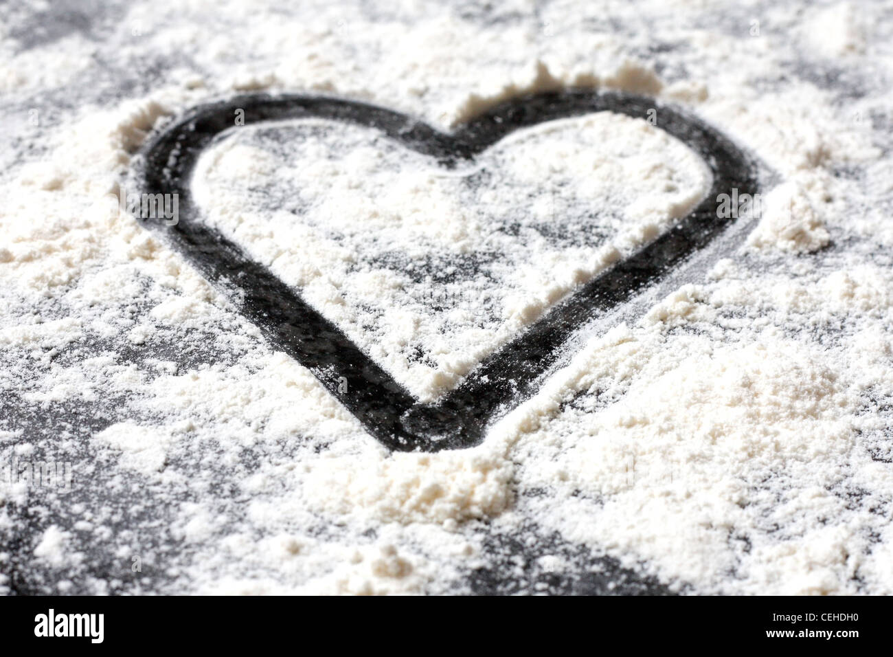 A love shape in white flour Stock Photo Alamy