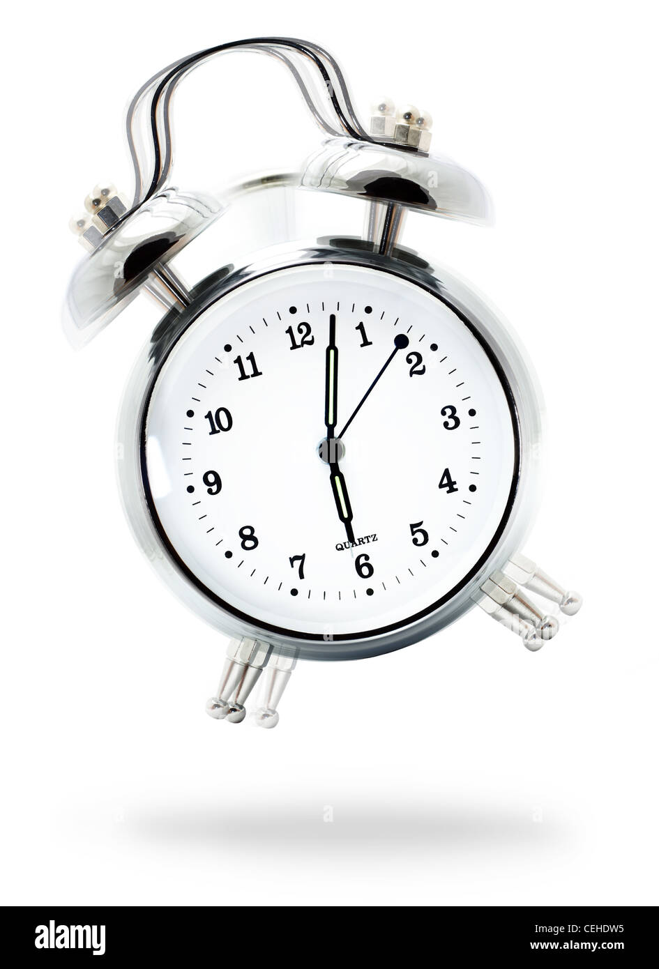 Classic white alarm clock ringing at six o'clock, isolated against a white background Stock Photo