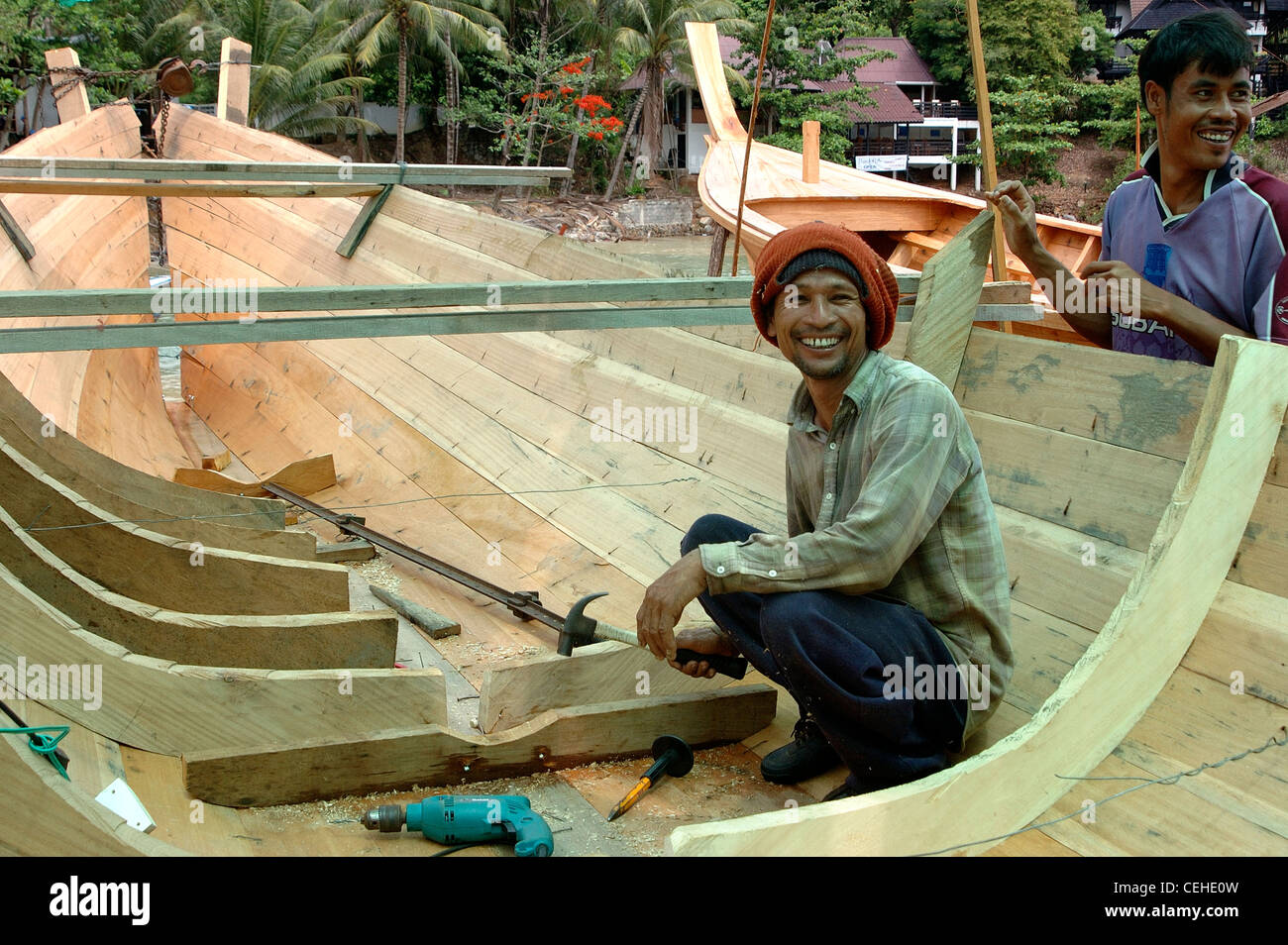 Thai fisherman building a new fishing boat after losing his in the Tsunami of December 2004 Stock Photo