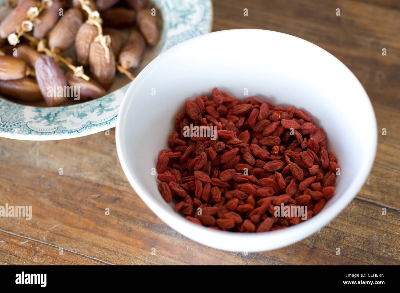 Dried Goji Berries, plus Dried Dates in a bowl Stock Photo