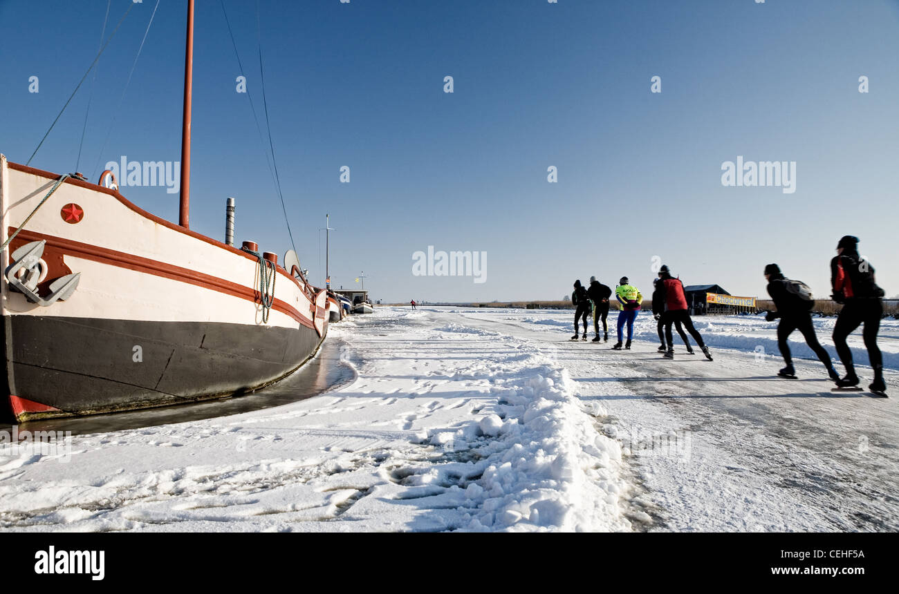 Ice skaters on the eleven cities course near Bolsward  - Friesland Stock Photo