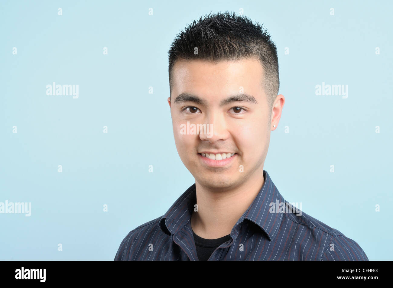 Head shot of a young Asian male in a blue and striped shirt Stock Photo -  Alamy