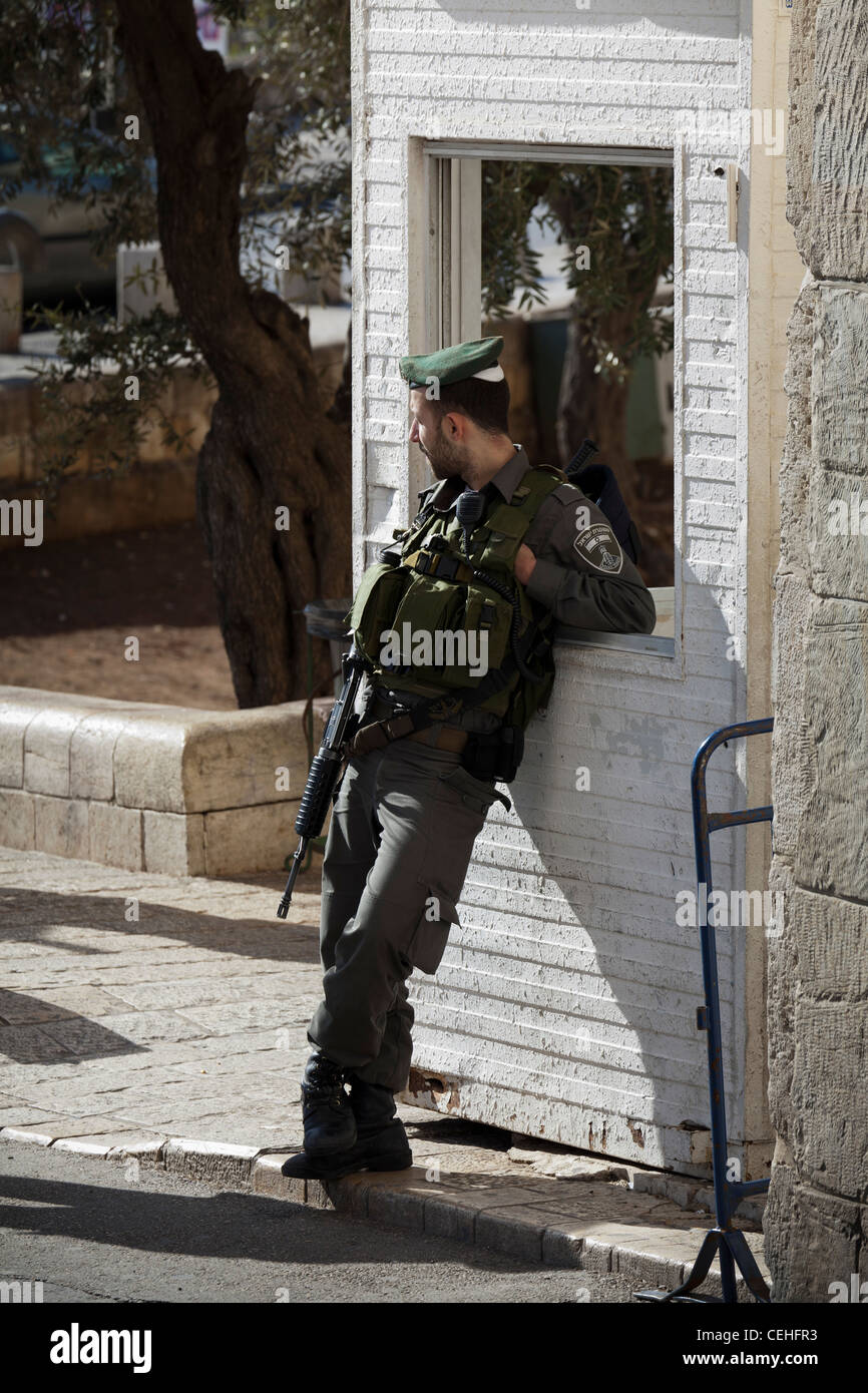 An Israeli soldier guards the Lion Gate into the Old City in Jerusalem in Israel Stock Photo
