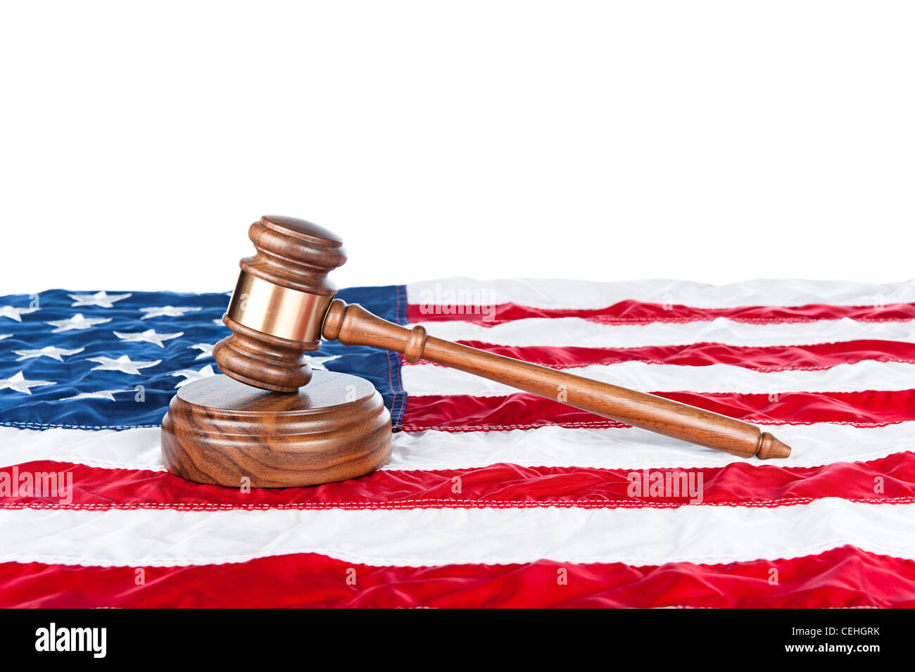 Gavel and sound block on an American flag with a white background for placement of copy. Stock Photo