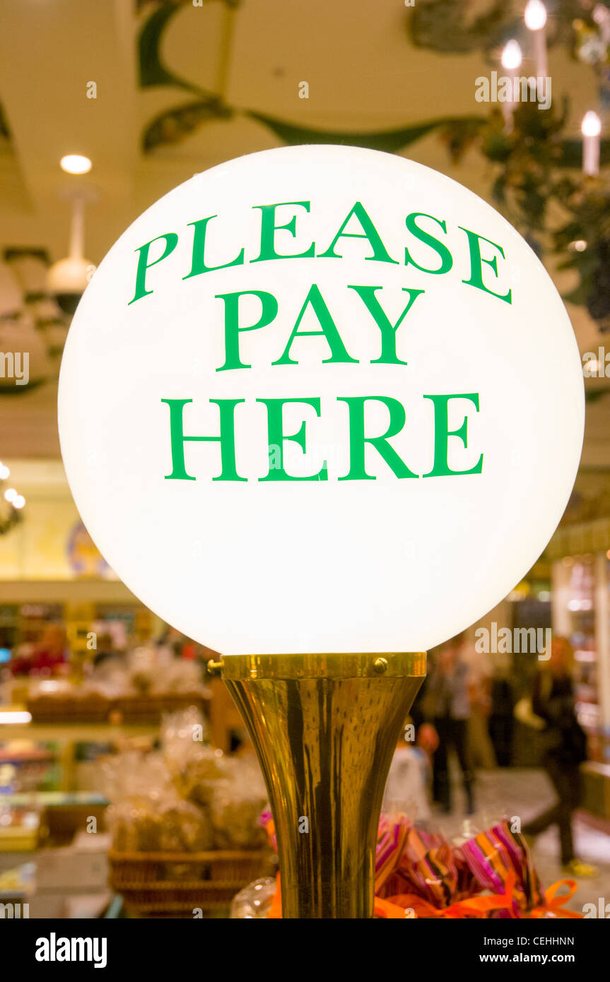 Please Pay Here sign in the Harrods Food Hall, London, England UK Stock Photo