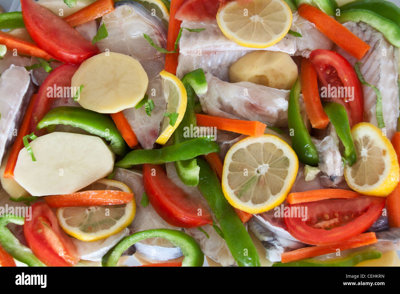 Catfish meat prepared with vegetables ready to be put in the oven. Nice colors Stock Photo