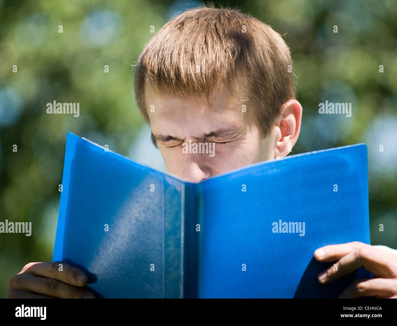 His Paper Young man with his papers Stock Photo - Alamy
