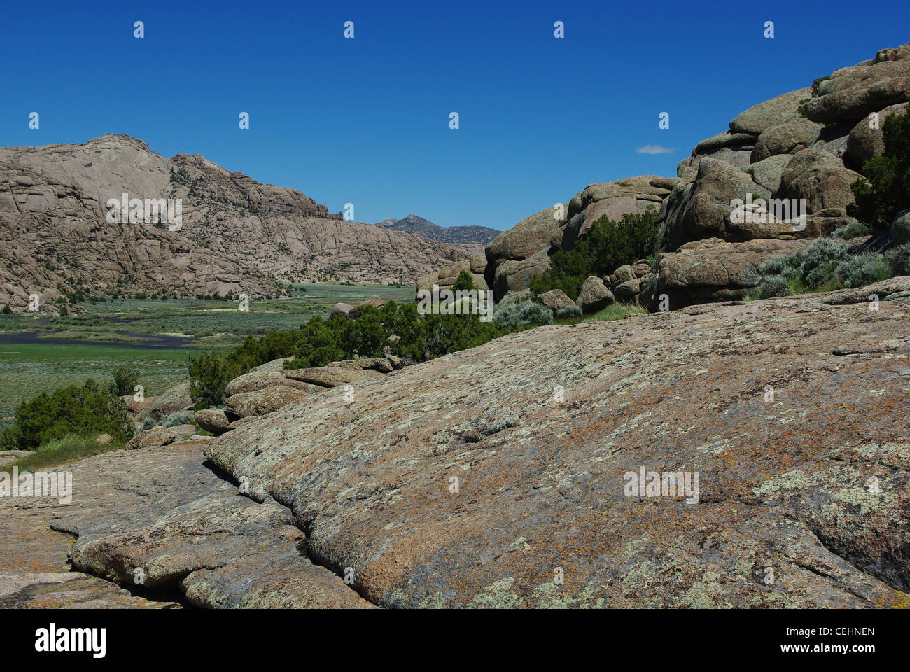 Rocks and green river valley at Split Rock, Wyoming Stock Photo