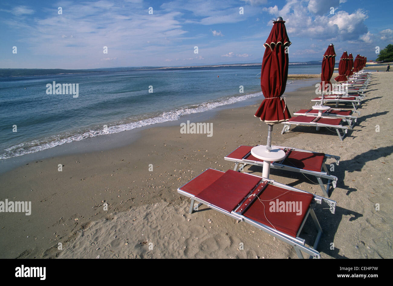 Lounge couches with sunshades at the public beach of Crikvenica during