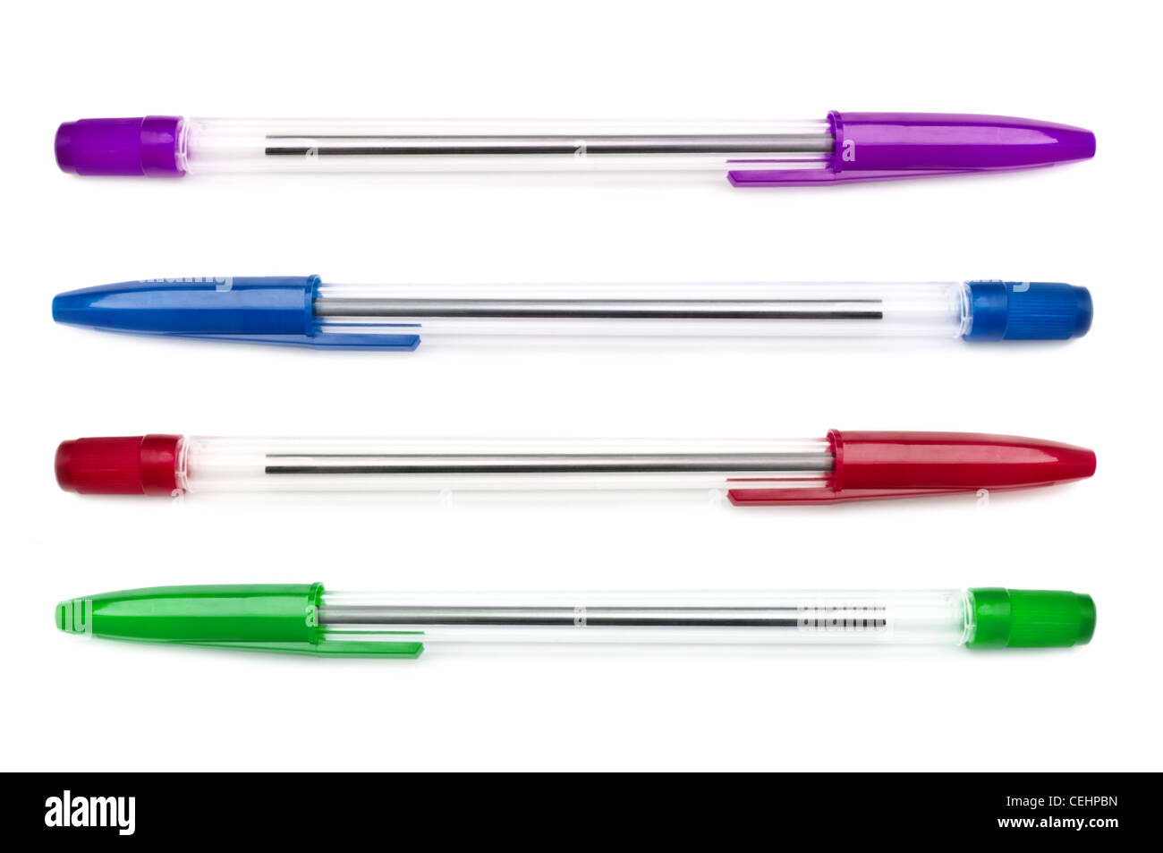 Close up capturing an arrangement of assorted biro pens over white. Stock Photo