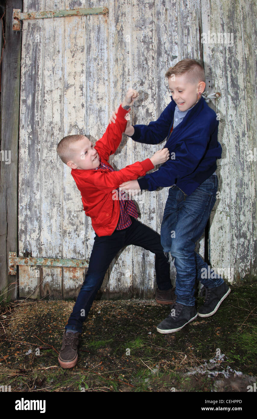 Two boys in casual clothes in white wooden background looking at each  other Two brothers posing Elder and younger brothers Happy childhood  concept Friendship Stock Photo  Adobe Stock