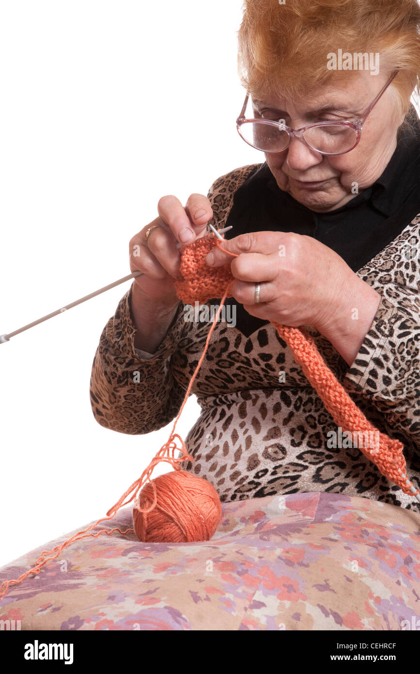 The old woman is engaged in knitting on a white background Stock Photo ...