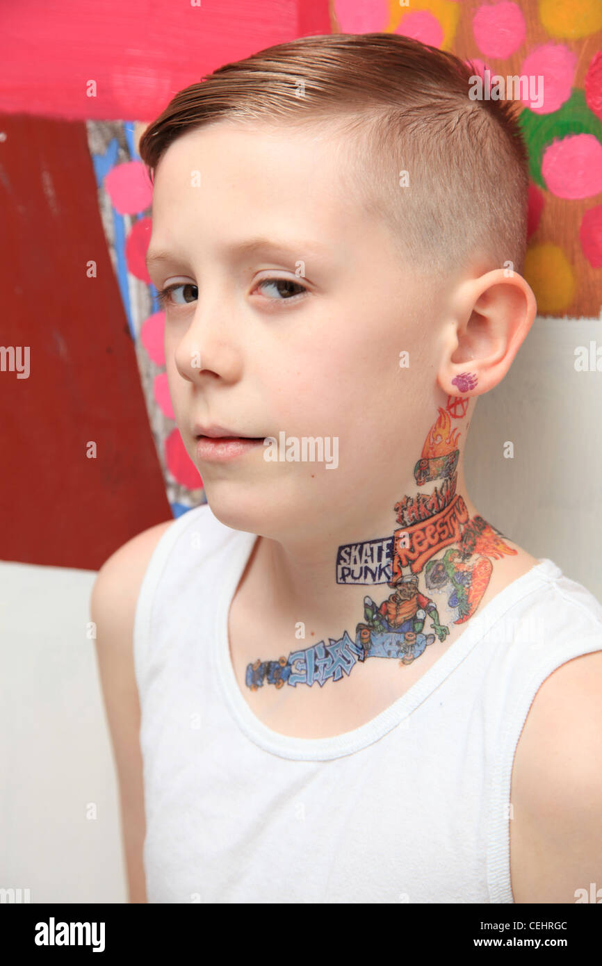 Portrait of an 8 year old boy with a tattoo and attitude. Stock Photo