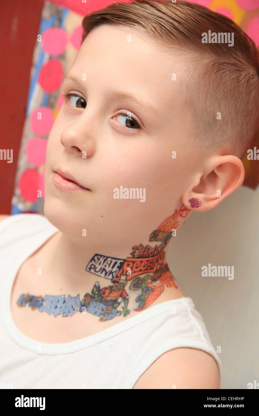 Portrait of an 8 year old boy with a tattoo and attitude. Stock Photo
