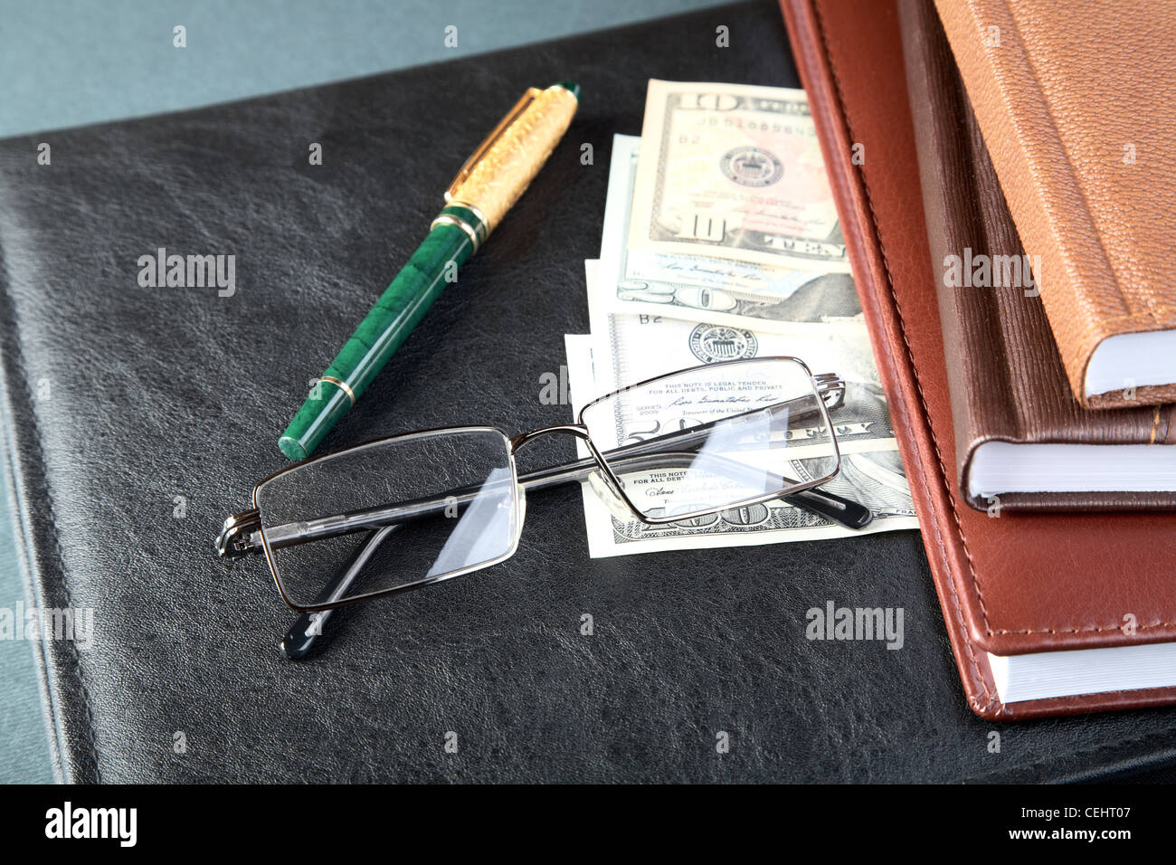 Folder organizers glasses pen and money on a table Stock Photo - Alamy
