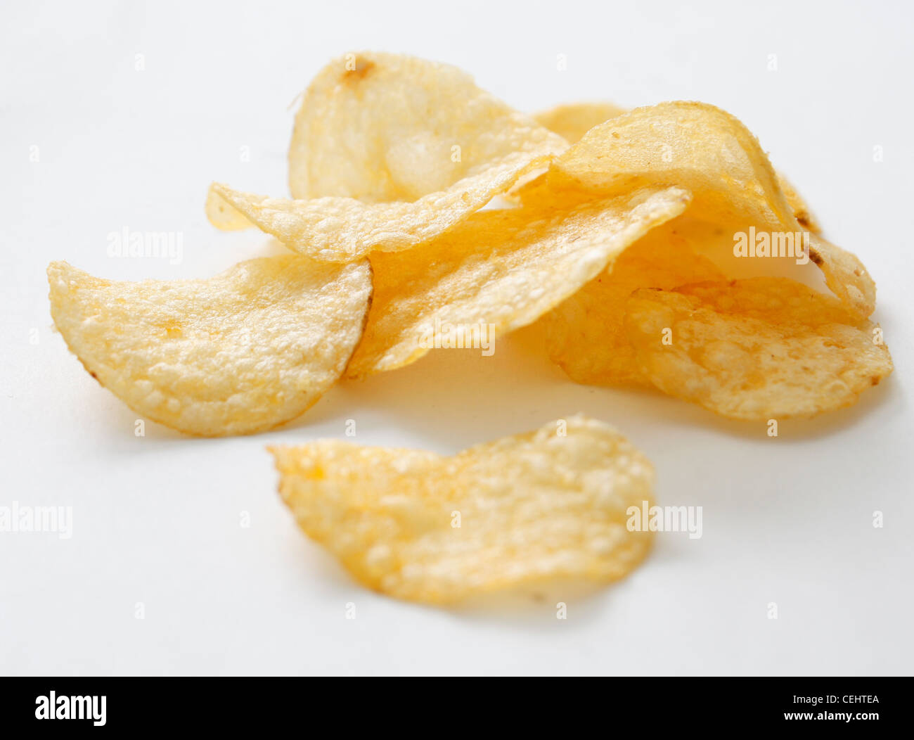 A bunch of potato chips on white Stock Photo