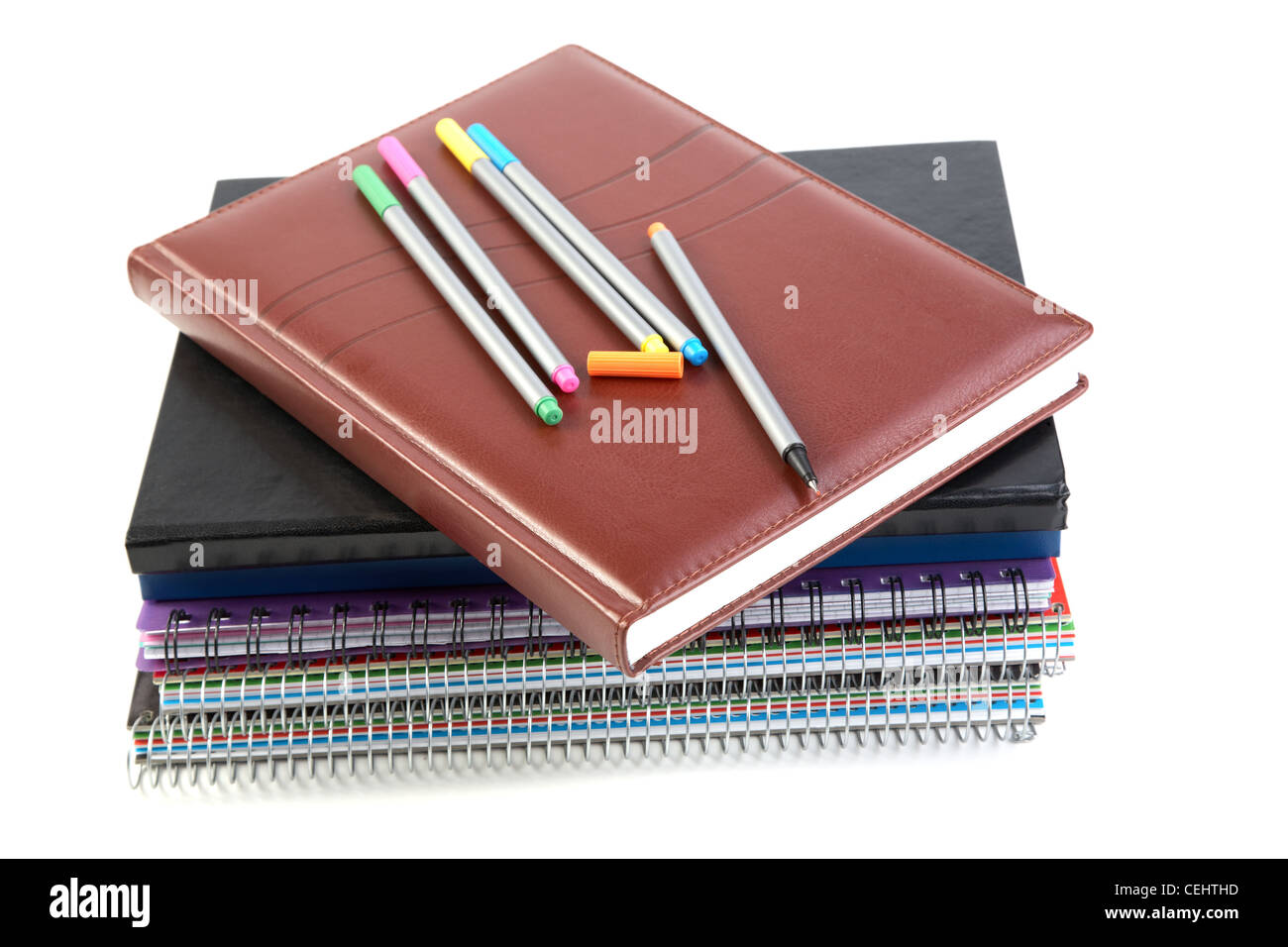 Felt-tip pen on a pile of writing-books and organizers white background Stock Photo