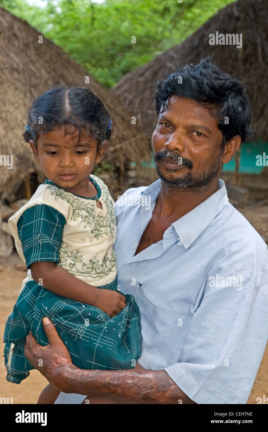 INDIA, Tamil Nadu, Dharasuram, man and child in front of house Stock Photo