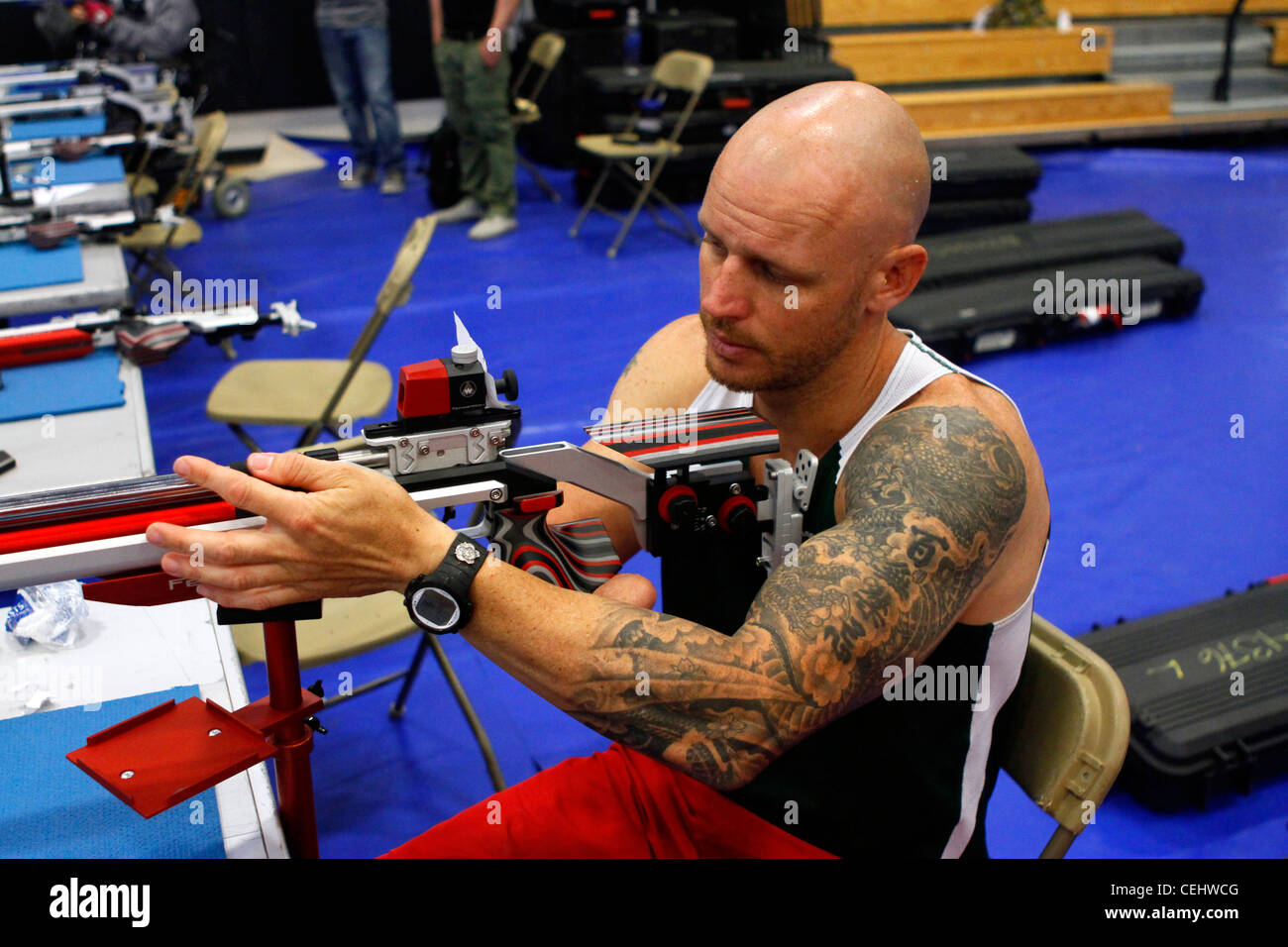 Active duty Australian sailor Paul de Gelder loads his rifle during practice at the Marine Corps Trials held on Marine Corps Base Camp Pendleton, Calif., Feb. 14, 2012. He is a member of the International team competing in the Trials, which are hosted by the United States Marine Corps Wounded Warrior Regiment. Stock Photo