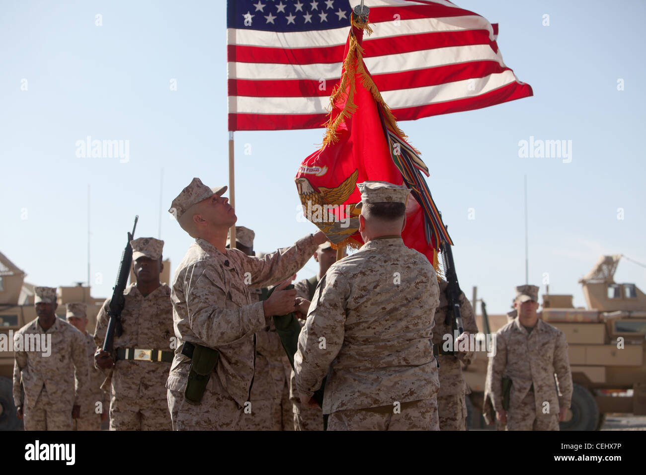 Brig. Gen. John J. Broadmeadow (right), commanding general of 1st Marine Logistics Group (Forward), and Sgt. Maj. Antonio Vizcarrondo (left), the group sergeant major, uncase the unit's colors during a transfer of authority ceremony aboard Camp Leatherneck, Afghanistan, Feb. 15. For the next year, 1st MLG (FWD) will serve as the Logistics Combat Element in southern Afghanistan. Stock Photo