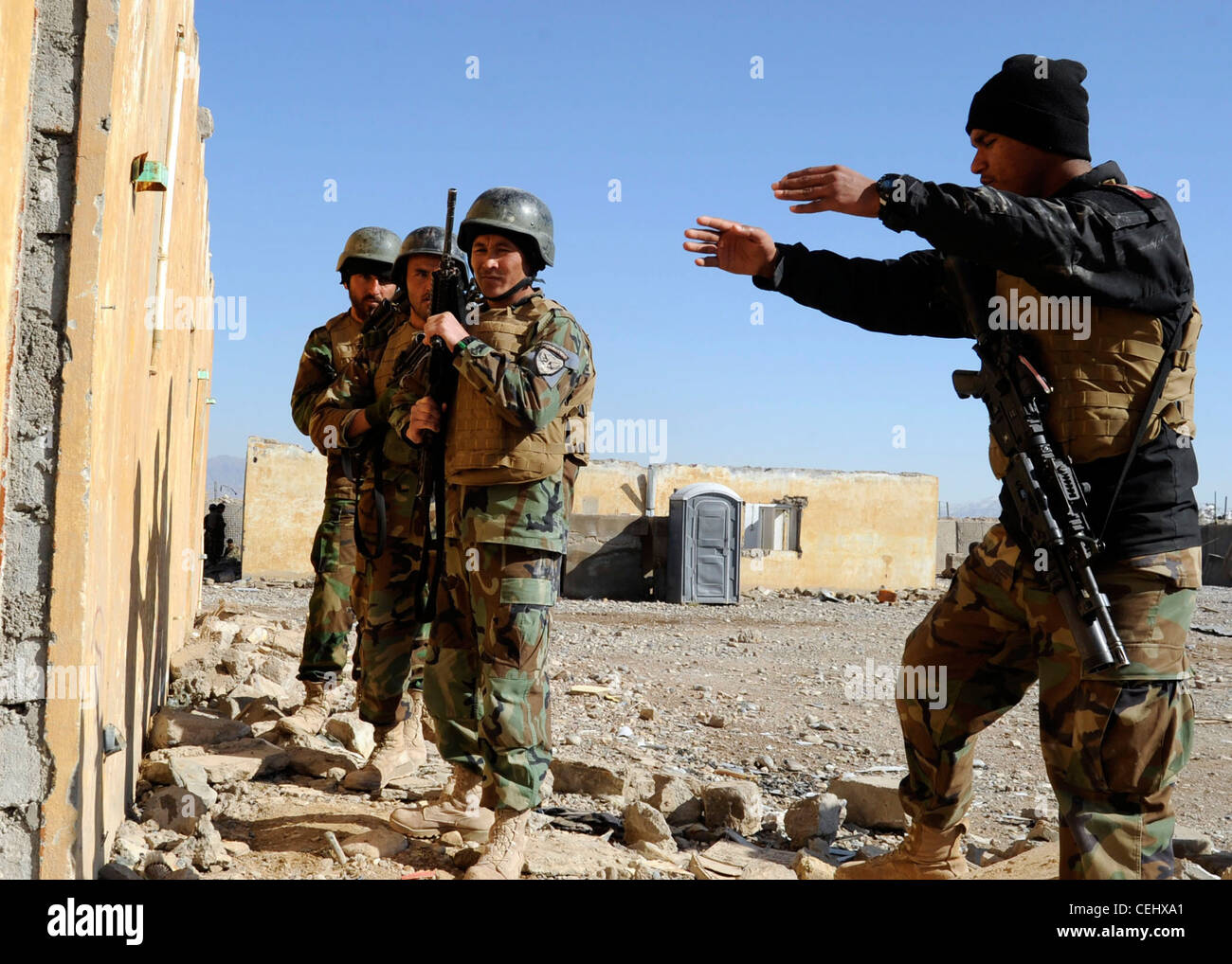 An instructor from the 8th Commando Kandak briefs other commandos during a training exercise in Tarin Kowt district, Uruzgan province, Afghanistan, Feb. 14. The 8th Commando Kandak partners with coalition Special Operations Forces to conduct operations throughout Uruzgan and Zabul provinces. Stock Photo