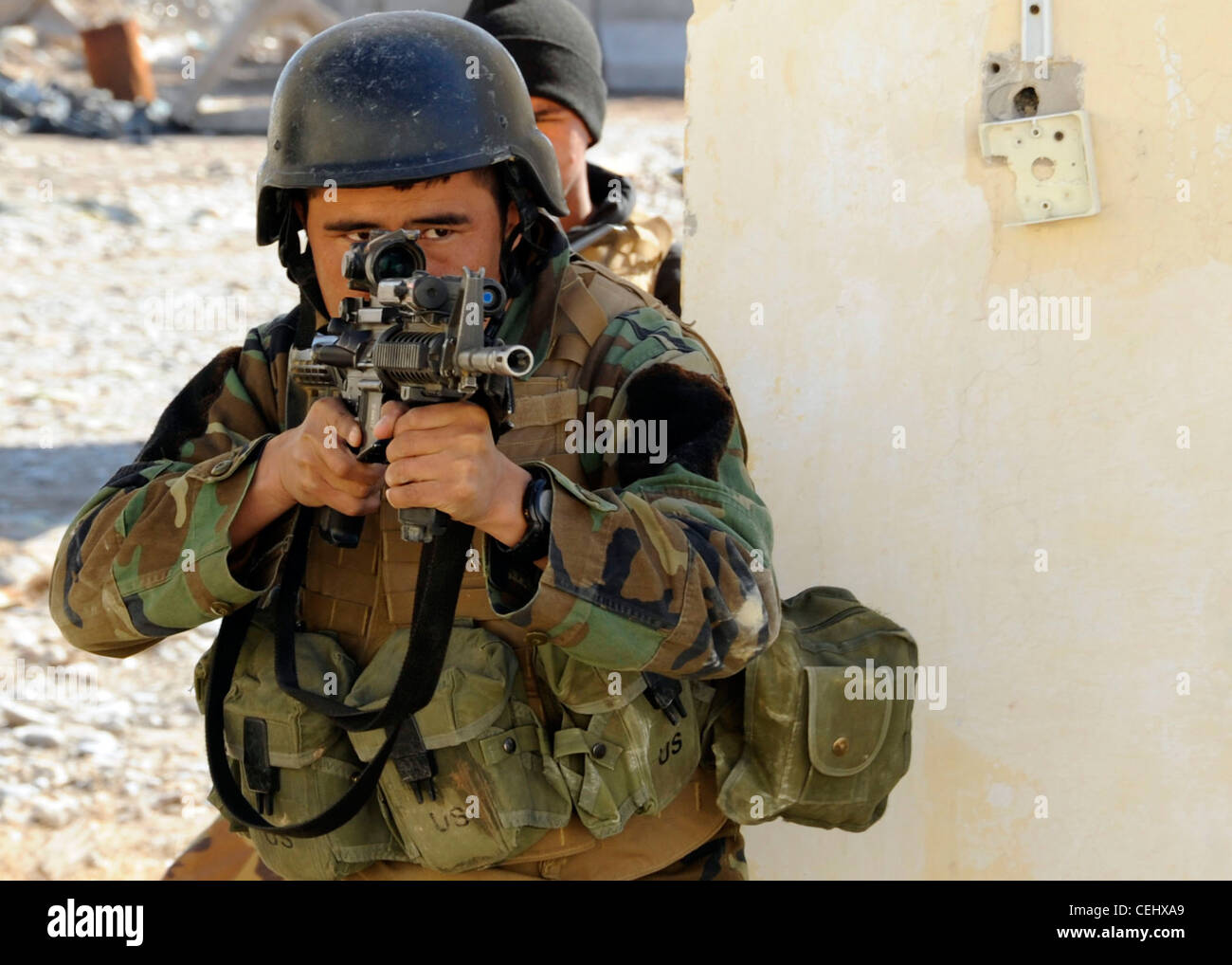 A soldier from the 8th Commando Kandak clears a room during a training exercise in Tarin Kowt district, Uruzgan province, Afghanistan, Feb. 14. The 8th Commando Kandak partners with coalition Special Operations Forces to conduct operations throughout Uruzgan and Zabul provinces. Stock Photo