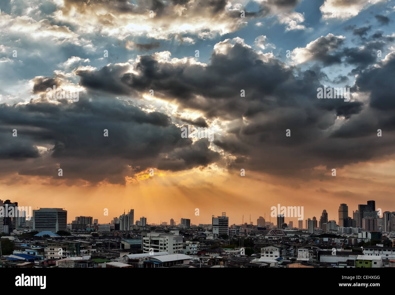 view of the city at sunset, the sun breaks through the clouds Stock ...