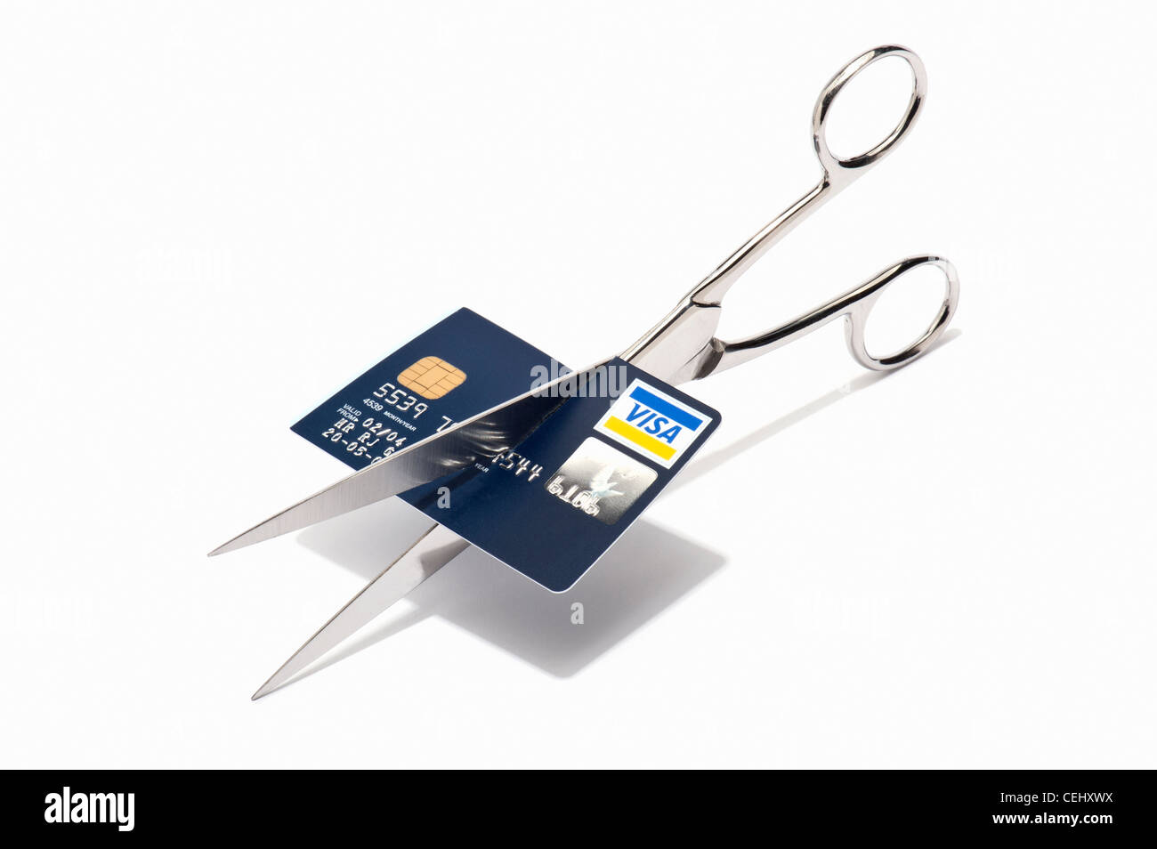 Scissors cutting up a visa credit card Stock Photo - Alamy