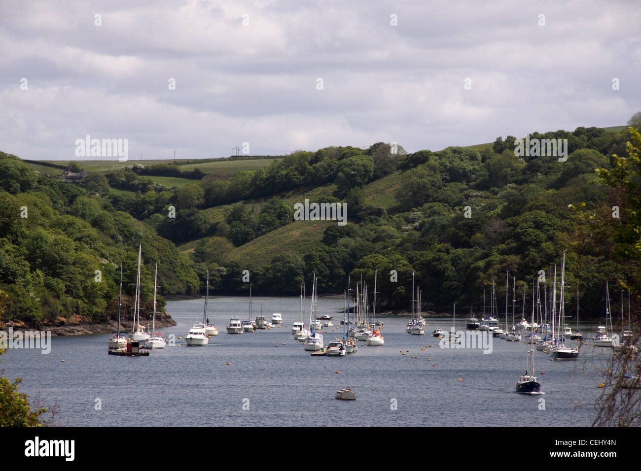 Fowey. View looking upstream of the River Fowey, with lots of boats anchored near Fowey and Polruan Stock Photo