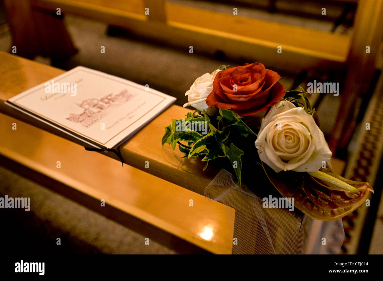 roses and booklet before a church wedding ceremony Stock Photo