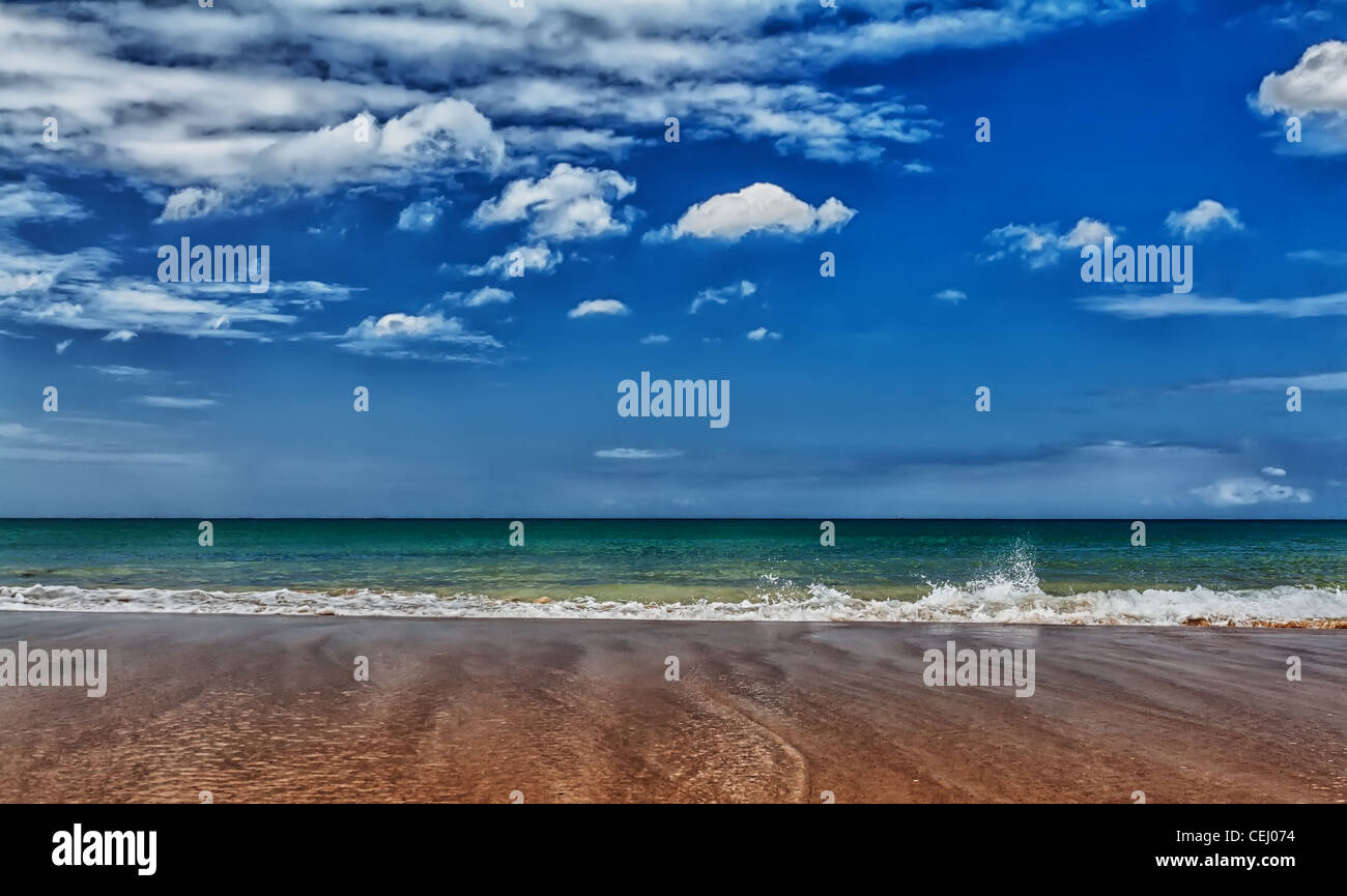 A tropical beach with blue sea and sky with clouds Stock Photo - Alamy