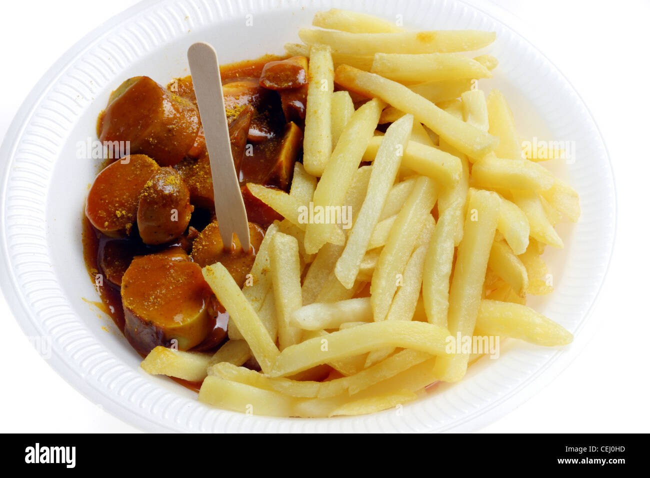 Nutrition, fast food. French fries with a  curry wurst, a Bratwurst style sausage with a spicy curry and tomato sauce. Stock Photo